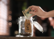 Hand placing money in tip jar
